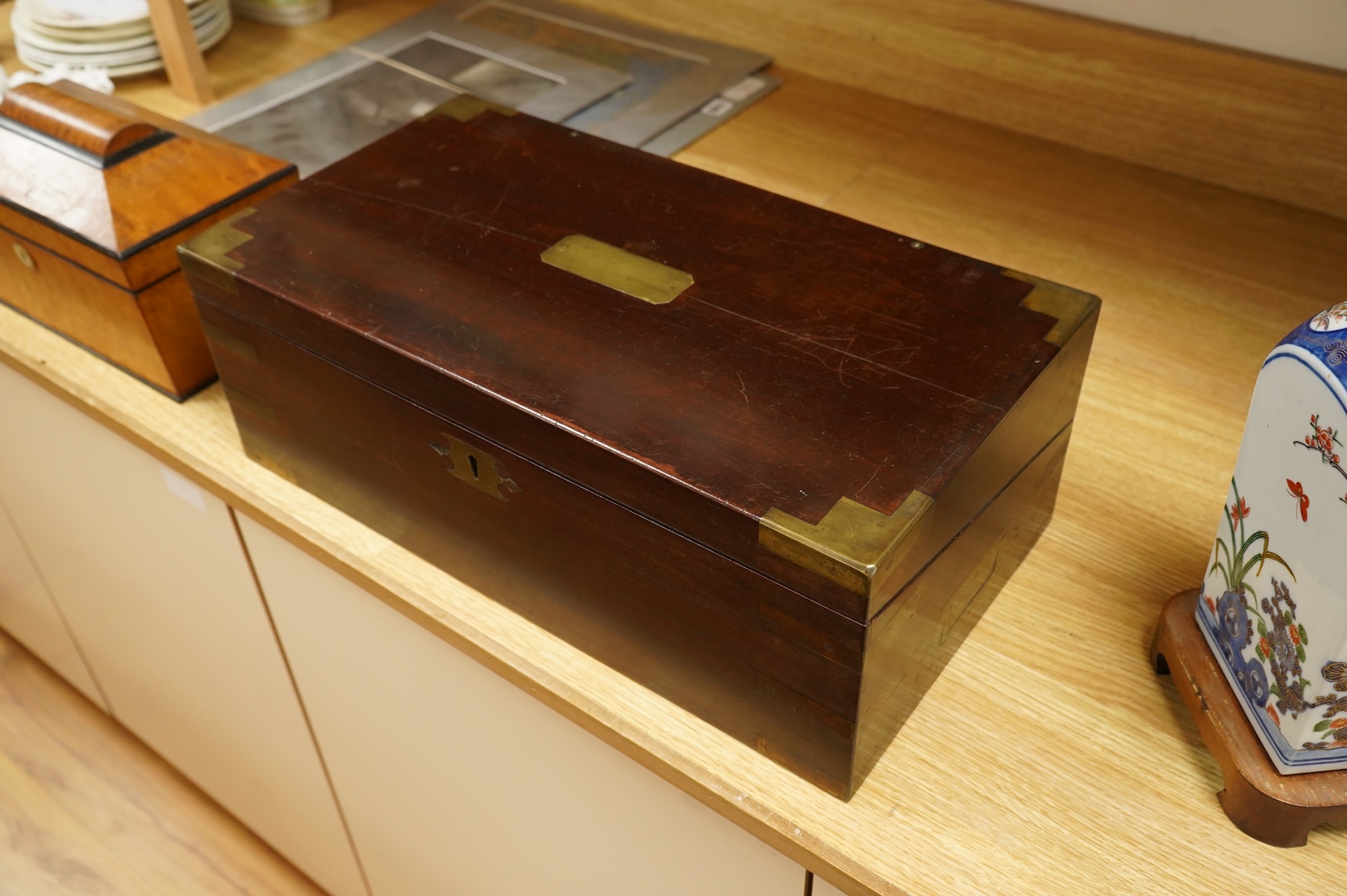 A bird’s-eye maple tea caddy and a brass mounted writing slope, latter 50cm wide